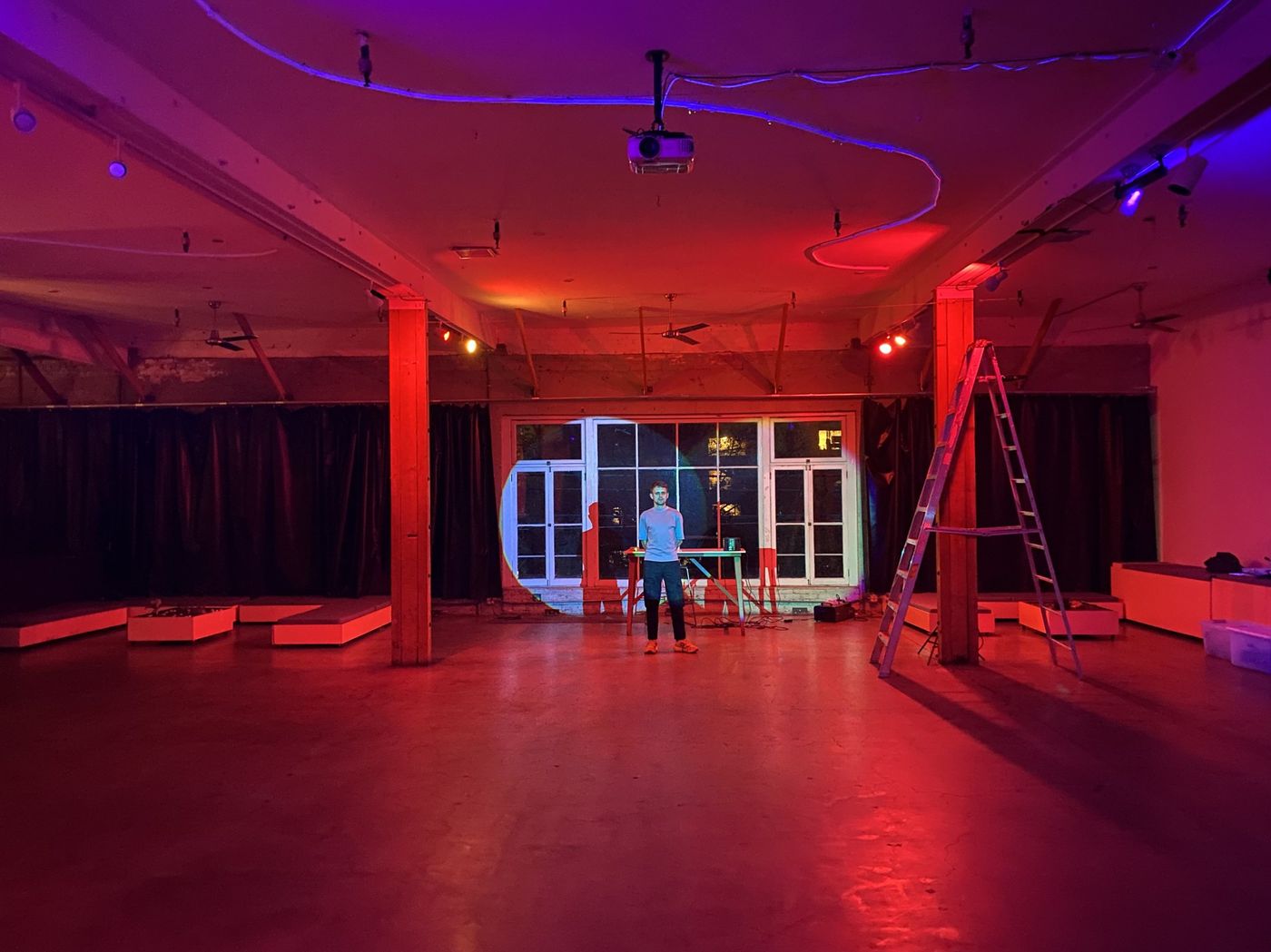 An event space at LINT lit in red